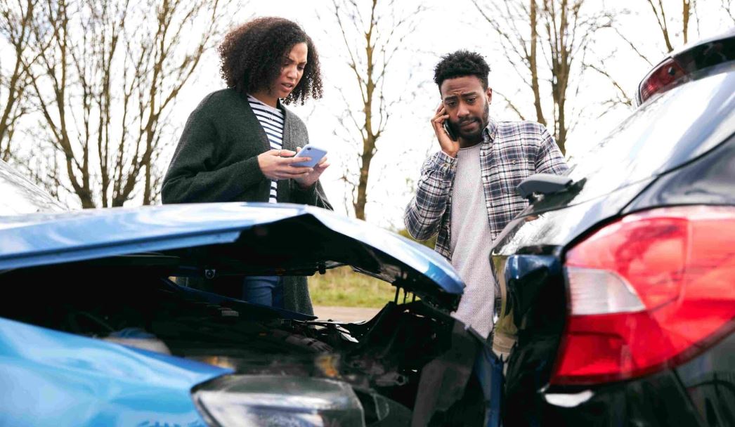 A car accident lawyer consulting with a client in an office setting, discussing legal options and reviewing documents.