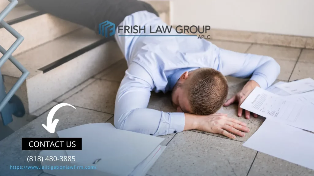 A professional slip and fall attorney discussing a case with a client in an office setting, with legal documents and a laptop on the table.