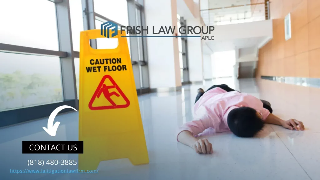 A slip and fall attorney discussing a case with a client in an office setting, with legal documents and a laptop on the table.