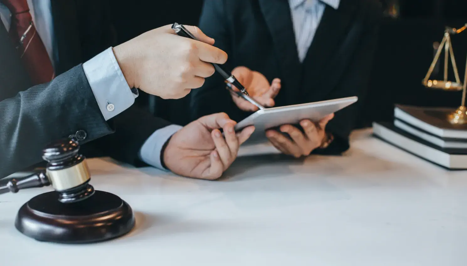 Personal injury attorney sitting at a desk with legal documents and a laptop, looking focused and professional.